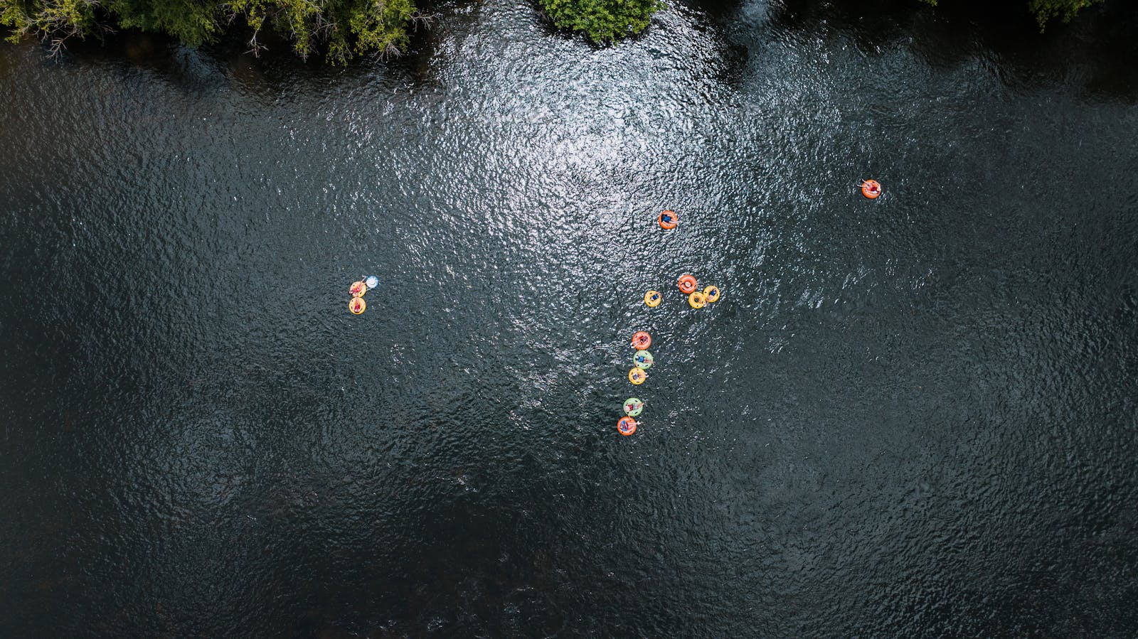 Aerial view of people floating down the Zumbro River on inner tubes